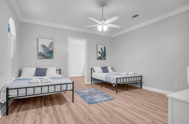 bedroom with ceiling fan, ornamental molding, and light wood-type flooring