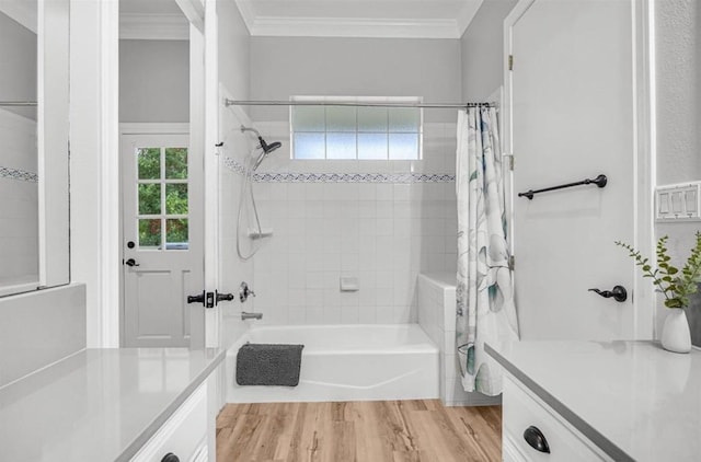 bathroom featuring ornamental molding, a healthy amount of sunlight, hardwood / wood-style floors, and shower / bath combo with shower curtain