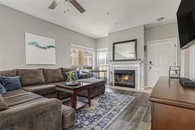 living room with ceiling fan, hardwood / wood-style floors, and a fireplace