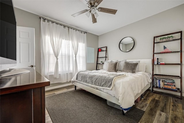 bedroom with dark wood-type flooring and ceiling fan