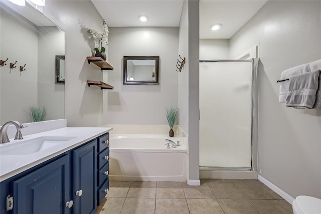 bathroom with tile patterned flooring, vanity, and independent shower and bath