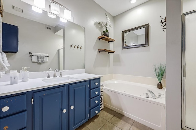 bathroom featuring tile patterned flooring, vanity, and separate shower and tub