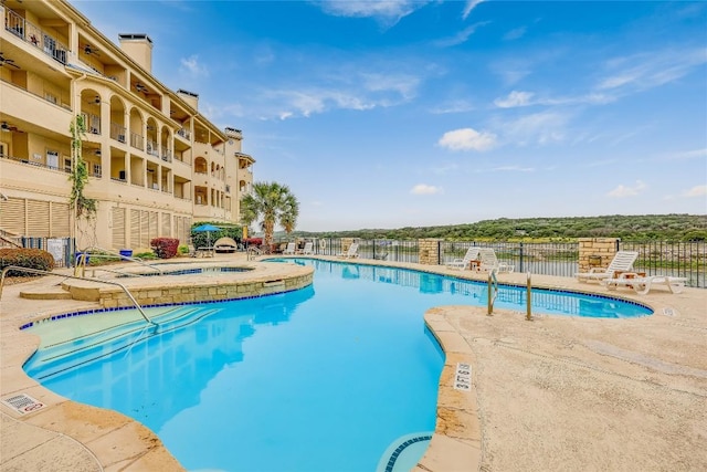 view of pool with a community hot tub