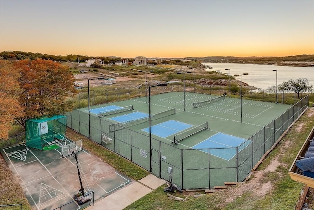 view of sport court with a water view