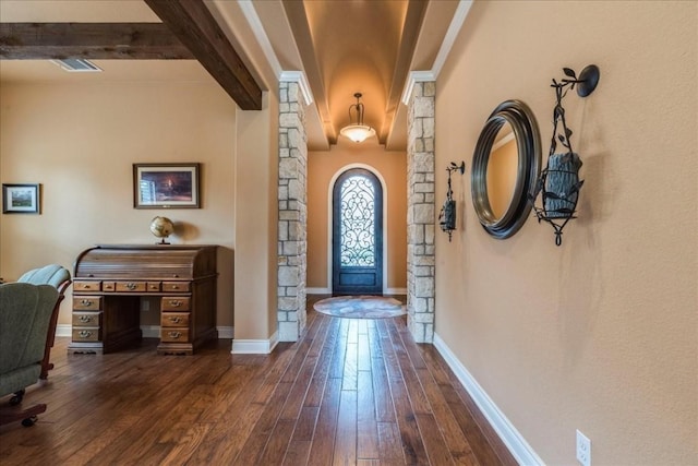 foyer featuring dark wood-type flooring and beamed ceiling