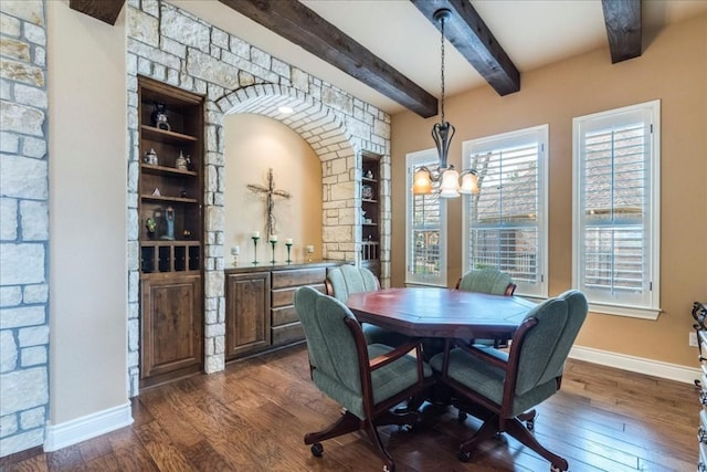 dining area with beamed ceiling, dark hardwood / wood-style floors, and a notable chandelier