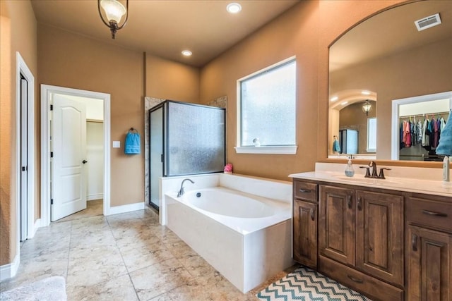 bathroom featuring plus walk in shower and vanity