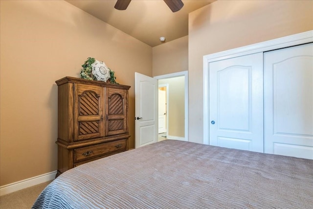 carpeted bedroom featuring lofted ceiling, ceiling fan, and a closet