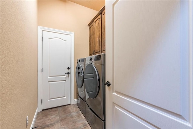 laundry room with cabinets and washing machine and dryer