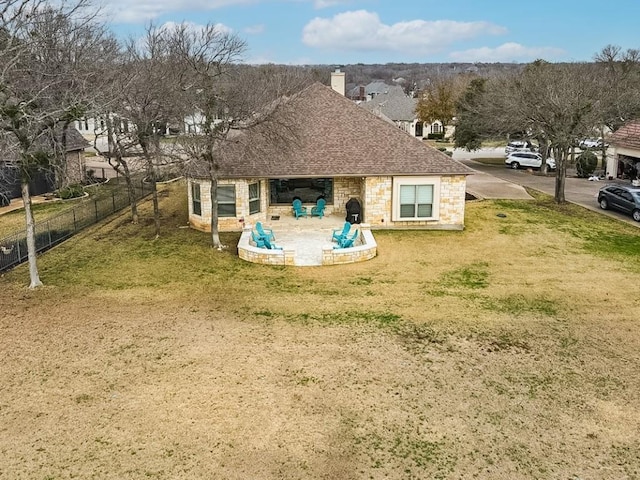 rear view of property with a yard and a patio area