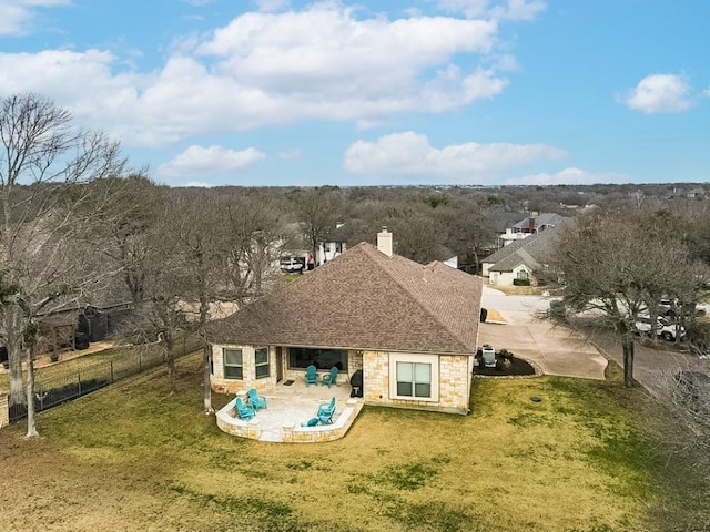 back of property with a yard and a patio