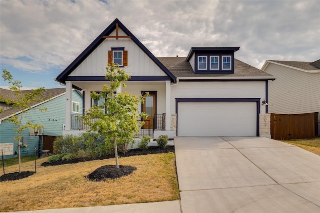 view of front of house featuring a porch, a garage, and a front lawn