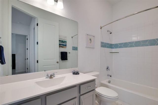 full bathroom with vanity, tiled shower / bath, and toilet