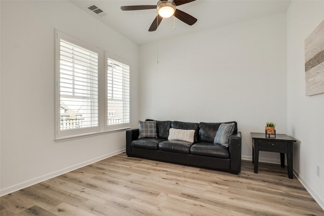 living room with light hardwood / wood-style floors and ceiling fan