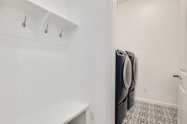 washroom with separate washer and dryer and light tile patterned floors