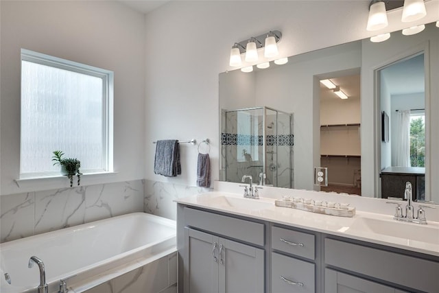 bathroom with vanity and independent shower and bath