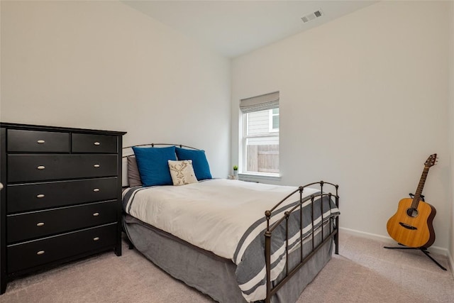 bedroom featuring light carpet