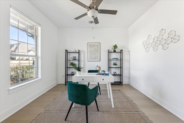 home office featuring ceiling fan, a wealth of natural light, and light wood-type flooring