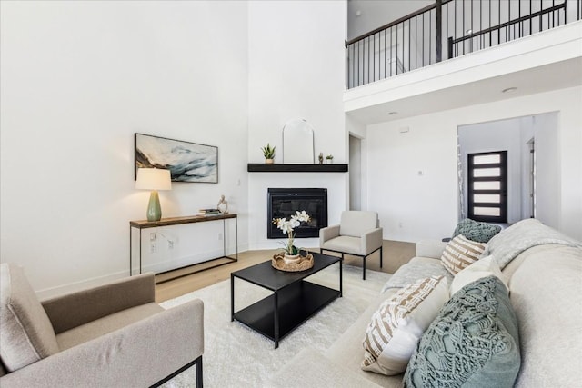 living room featuring wood-type flooring and a high ceiling