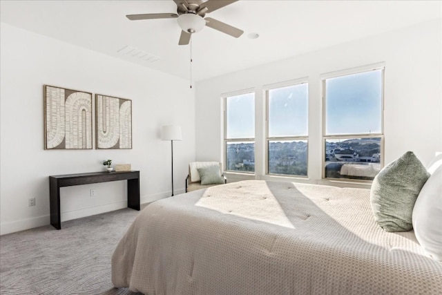 bedroom featuring ceiling fan and light carpet