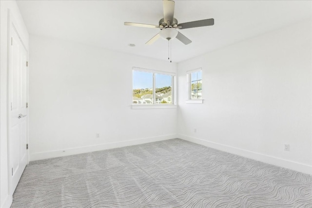 empty room featuring light carpet and ceiling fan