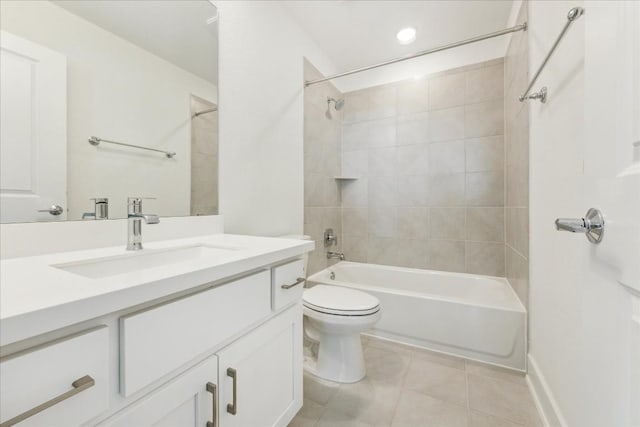 full bathroom featuring tile patterned flooring, vanity, tiled shower / bath combo, and toilet