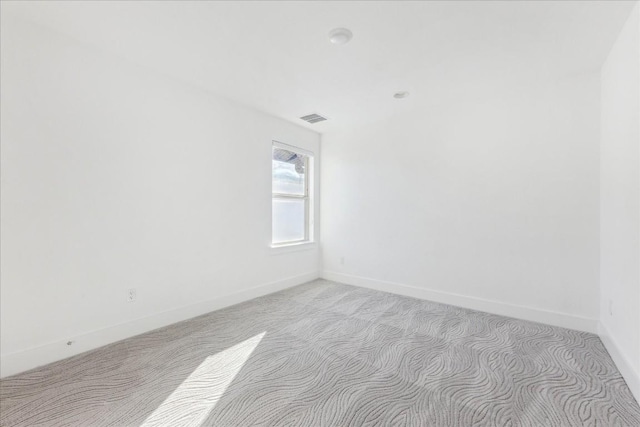 empty room with light colored carpet