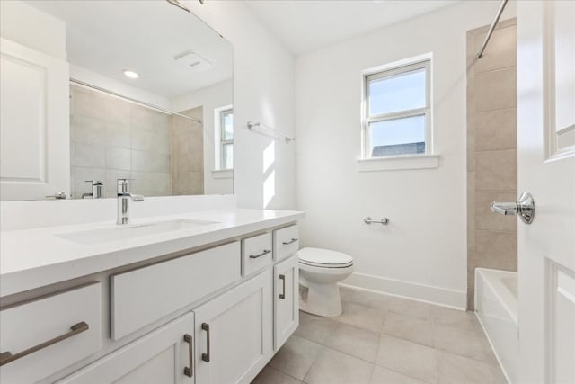 full bathroom featuring tiled shower / bath, tile patterned floors, toilet, and vanity