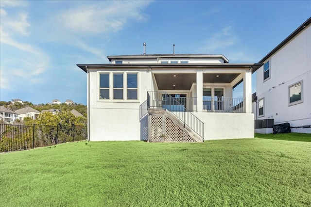 rear view of property featuring central AC and a yard