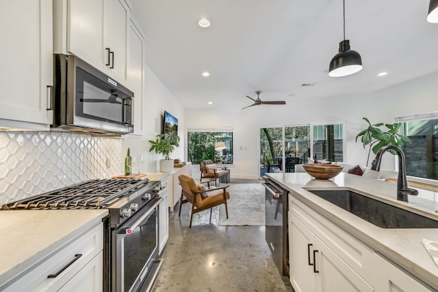 kitchen with white cabinetry, sink, pendant lighting, and appliances with stainless steel finishes