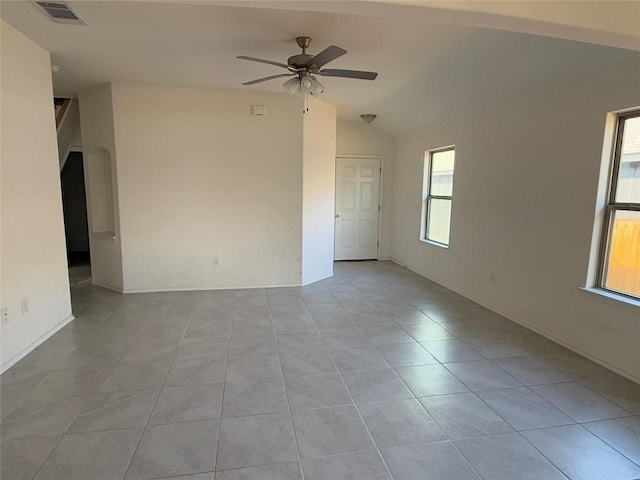 tiled spare room featuring ceiling fan and vaulted ceiling