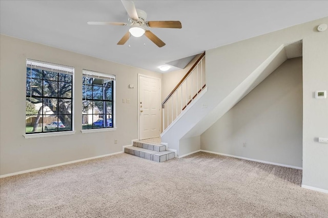 unfurnished living room featuring ceiling fan and carpet floors