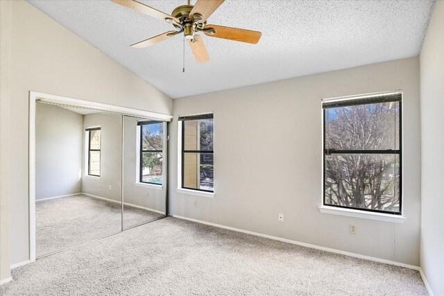 11901 Swearingen Dr Unit 37, Austin, TX 78758 - unfurnished bedroom featuring carpet, a textured ceiling, vaulted ceiling, a ceiling fan, and a closet