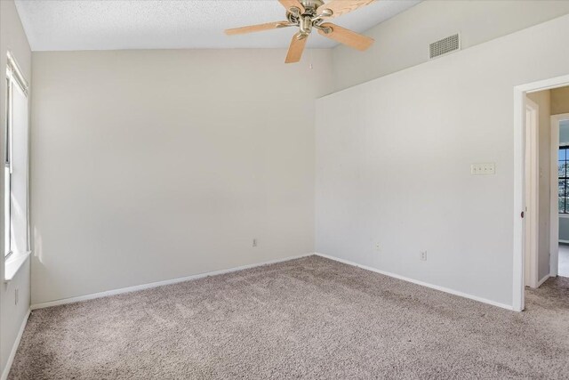 carpeted spare room with ceiling fan and a textured ceiling