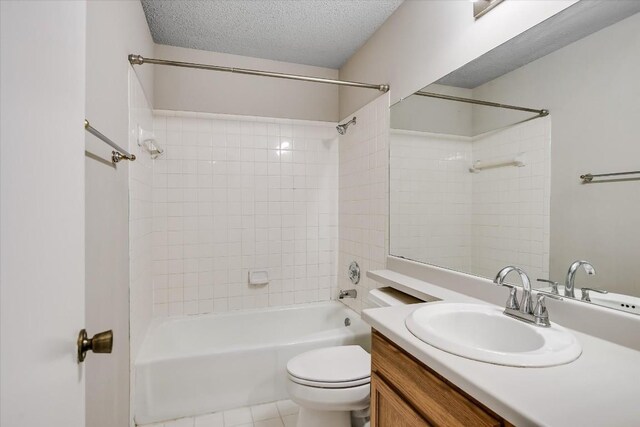 full bathroom featuring vanity, a textured ceiling, tile patterned floors, toilet, and tiled shower / bath