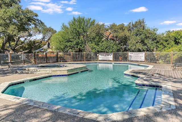 view of swimming pool with a community hot tub