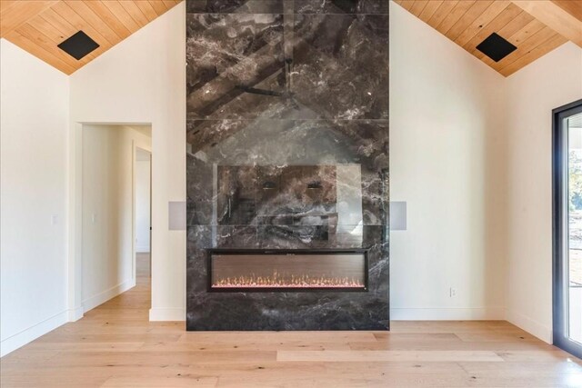 room details with a high end fireplace, wood ceiling, and wood finished floors