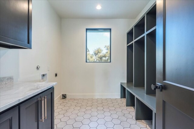 laundry area with recessed lighting, baseboards, electric dryer hookup, and cabinet space