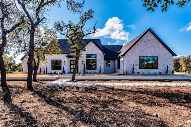 modern inspired farmhouse with stone siding