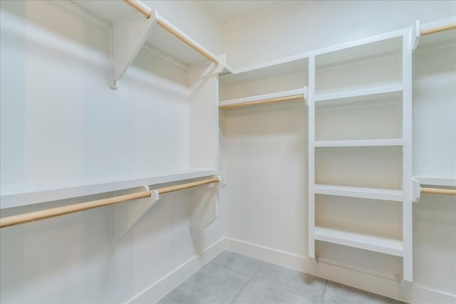 walk in closet with tile patterned floors