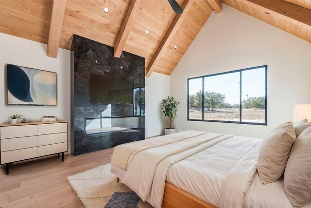 bedroom featuring beam ceiling, light wood finished floors, high vaulted ceiling, recessed lighting, and wood ceiling