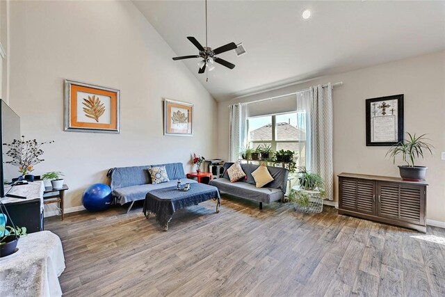 living room with wood-type flooring, high vaulted ceiling, and ceiling fan