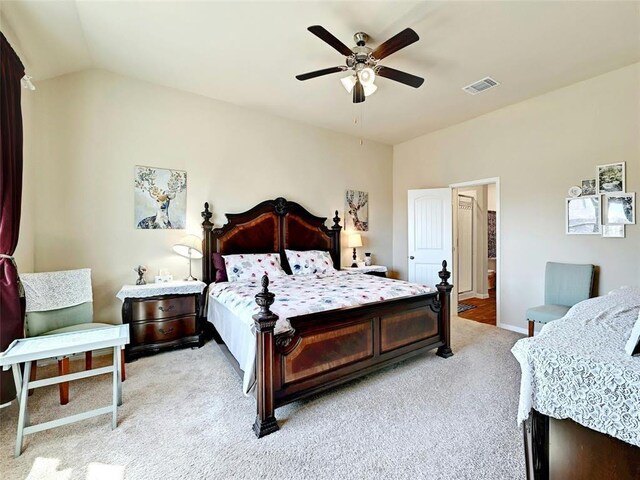 bedroom featuring ceiling fan, light colored carpet, and lofted ceiling