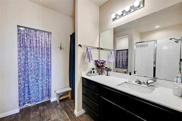 bathroom with a shower with curtain, vanity, and hardwood / wood-style floors