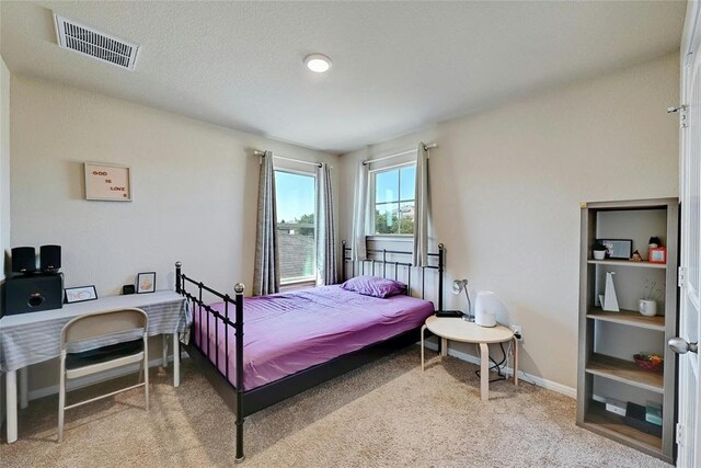 bedroom featuring light colored carpet