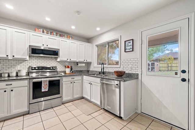 kitchen featuring appliances with stainless steel finishes, sink, and white cabinets