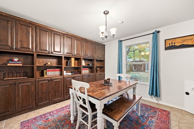 tiled dining space with a chandelier