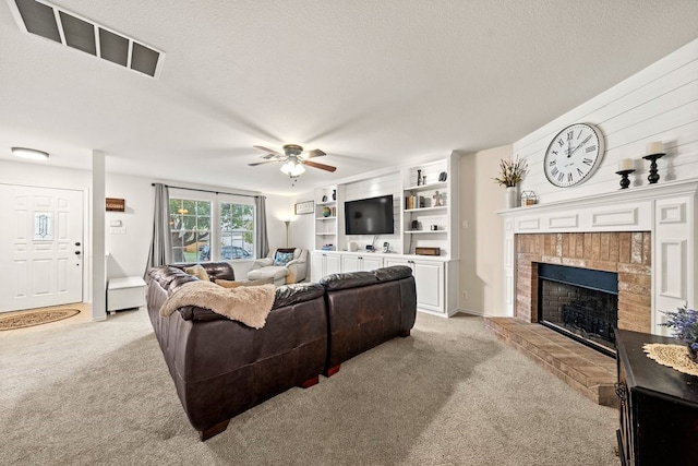 living room with light colored carpet, a textured ceiling, and a fireplace