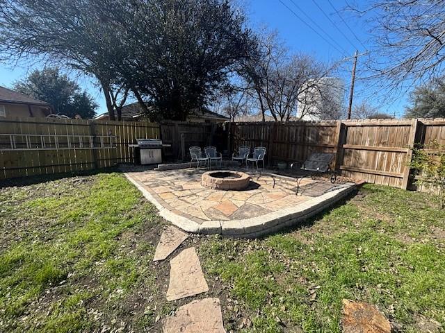 view of yard featuring an outdoor fire pit and a patio area