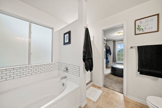 bathroom featuring toilet and plus walk in shower